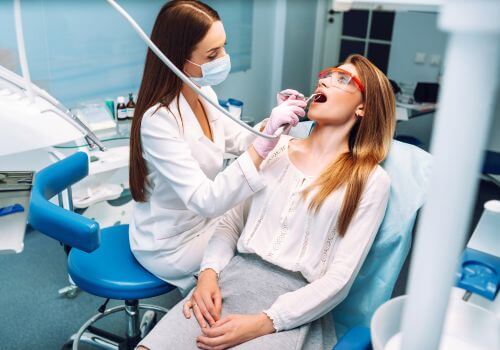Woman at dentist learning about laser dentistry.